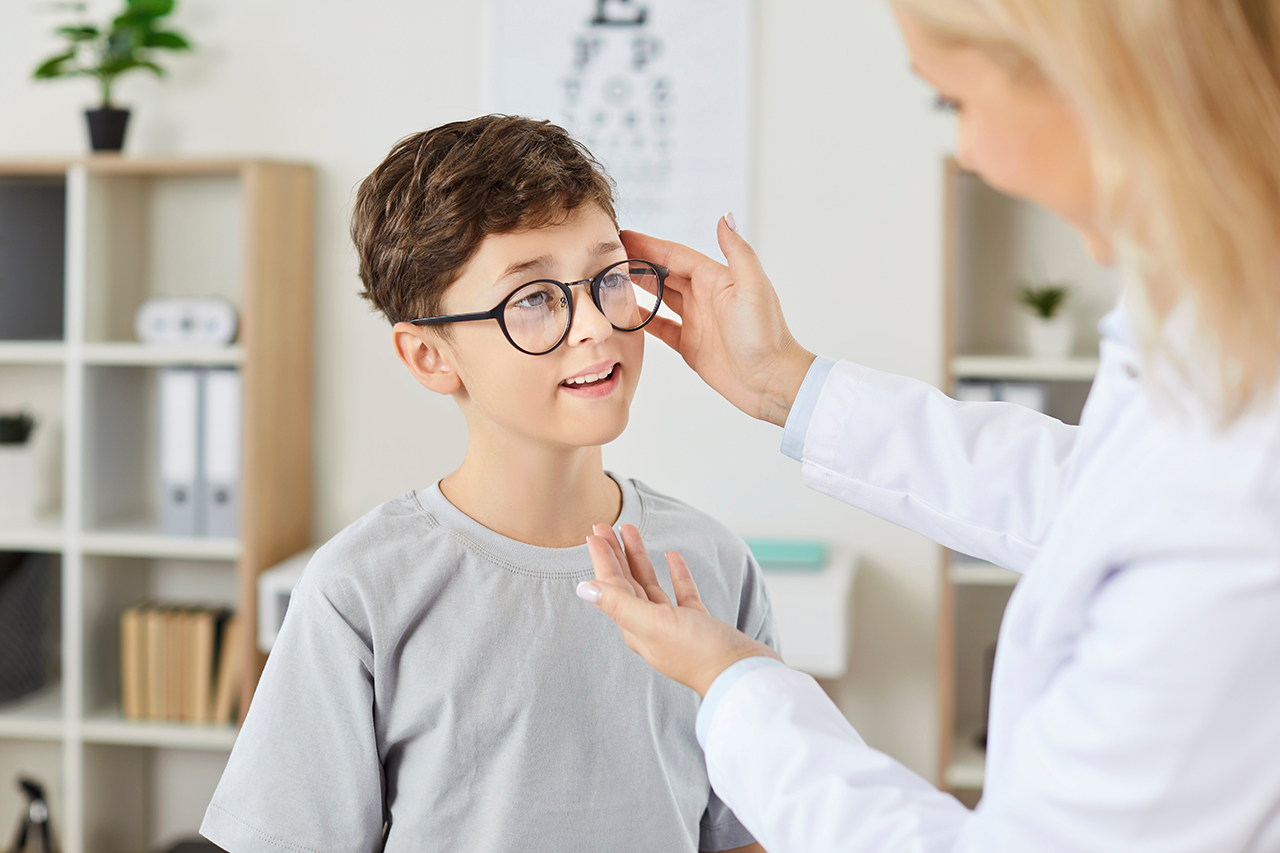 Optician with young patient at Family Eyecare